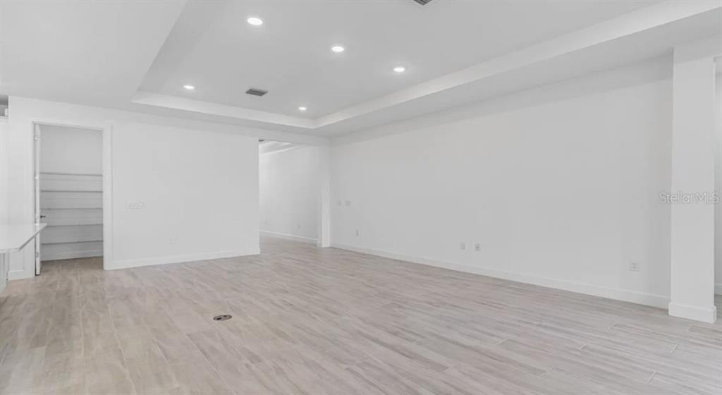 899 Arbor Grn Trail St. Cloud, FL 34771 - Photo 12 of 34 wooden floor in an empty room with a window