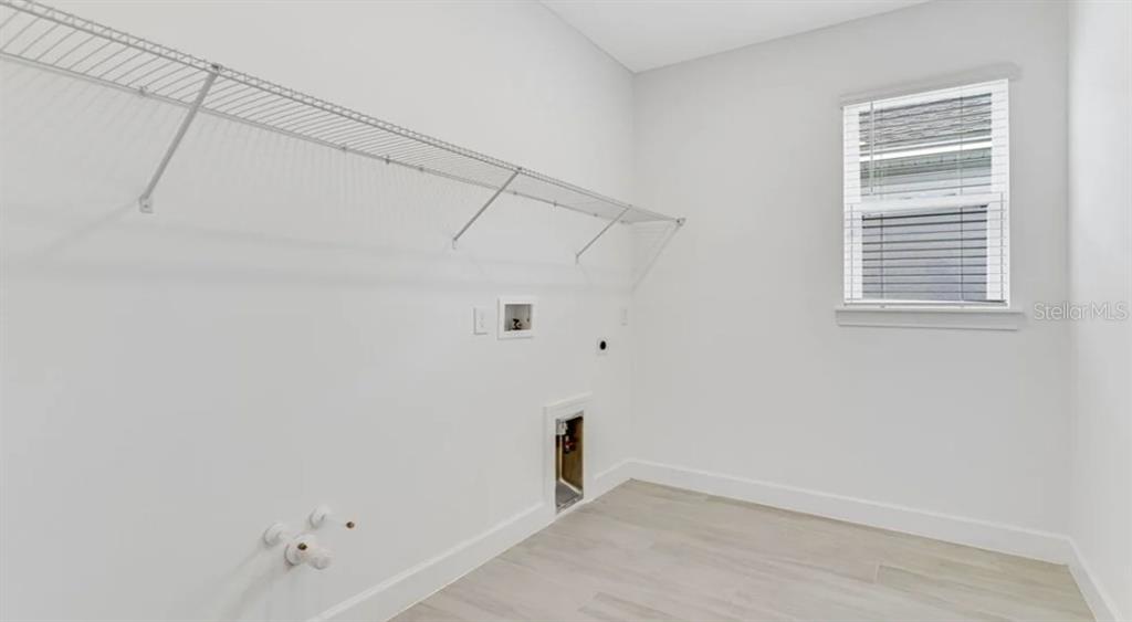 899 Arbor Grn Trail St. Cloud, FL 34771 - Photo 17 of 34 a view of a room with racks on the wall