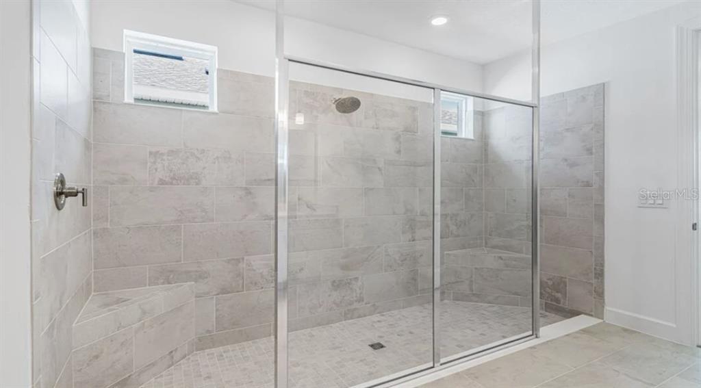 899 Arbor Grn Trail St. Cloud, FL 34771 - Photo 22 of 34 a bathroom with a shower