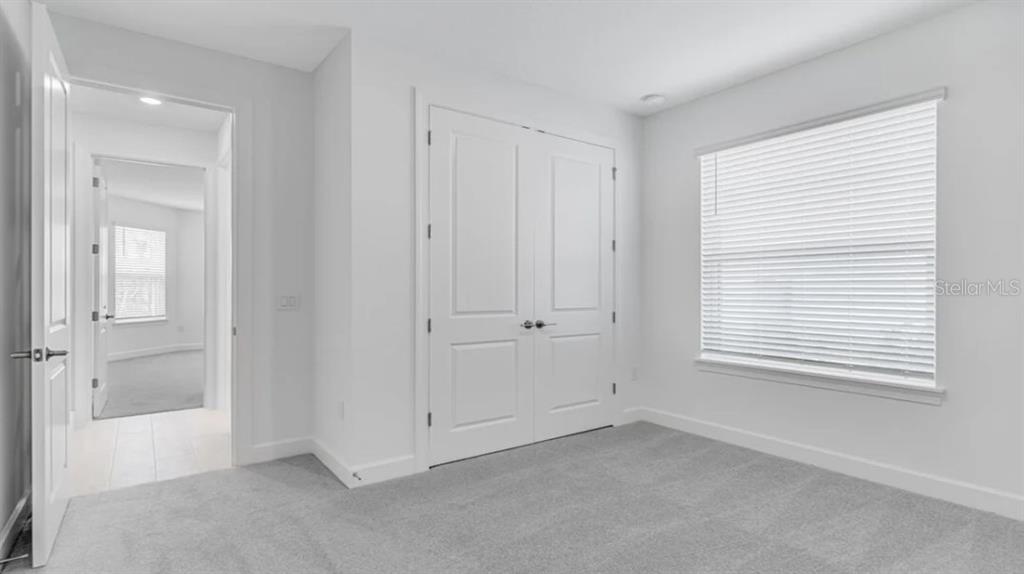899 Arbor Grn Trail St. Cloud, FL 34771 - Photo 23 of 34 a view of an empty room with window and closet area