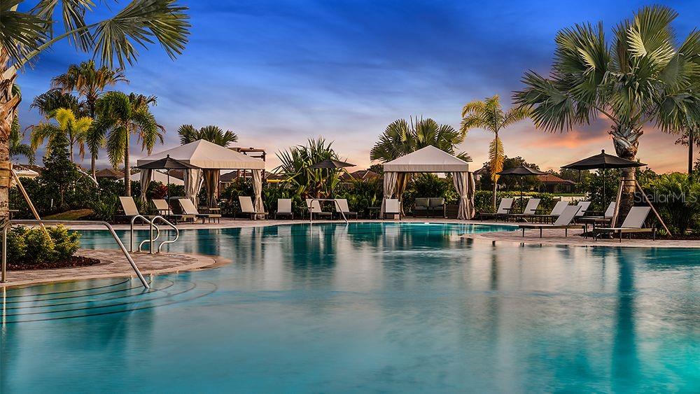 899 Arbor Grn Trail St. Cloud, FL 34771 - Photo 28 of 34 a view of a swimming pool with a table and chairs