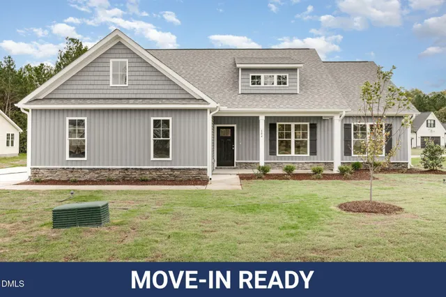 a view of a house with swimming pool and a yard