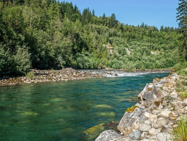 a view of a mountain range with lush green forest