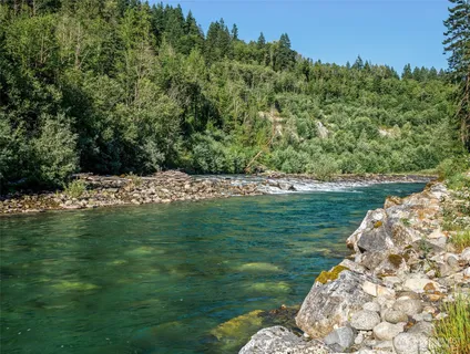 a view of a mountain range with lush green forest