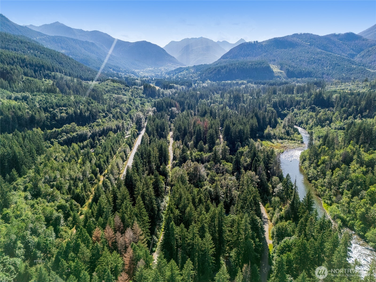 76011 Northeast 123rd Street Skykomish, WA 98288 - Photo 16 of 29 a view of a lush green hillside and houses