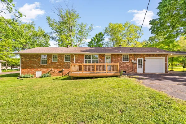 a view of a house with swimming pool and porch with furniture