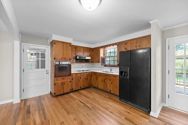 a kitchen with stainless steel appliances a refrigerator and a stove top oven