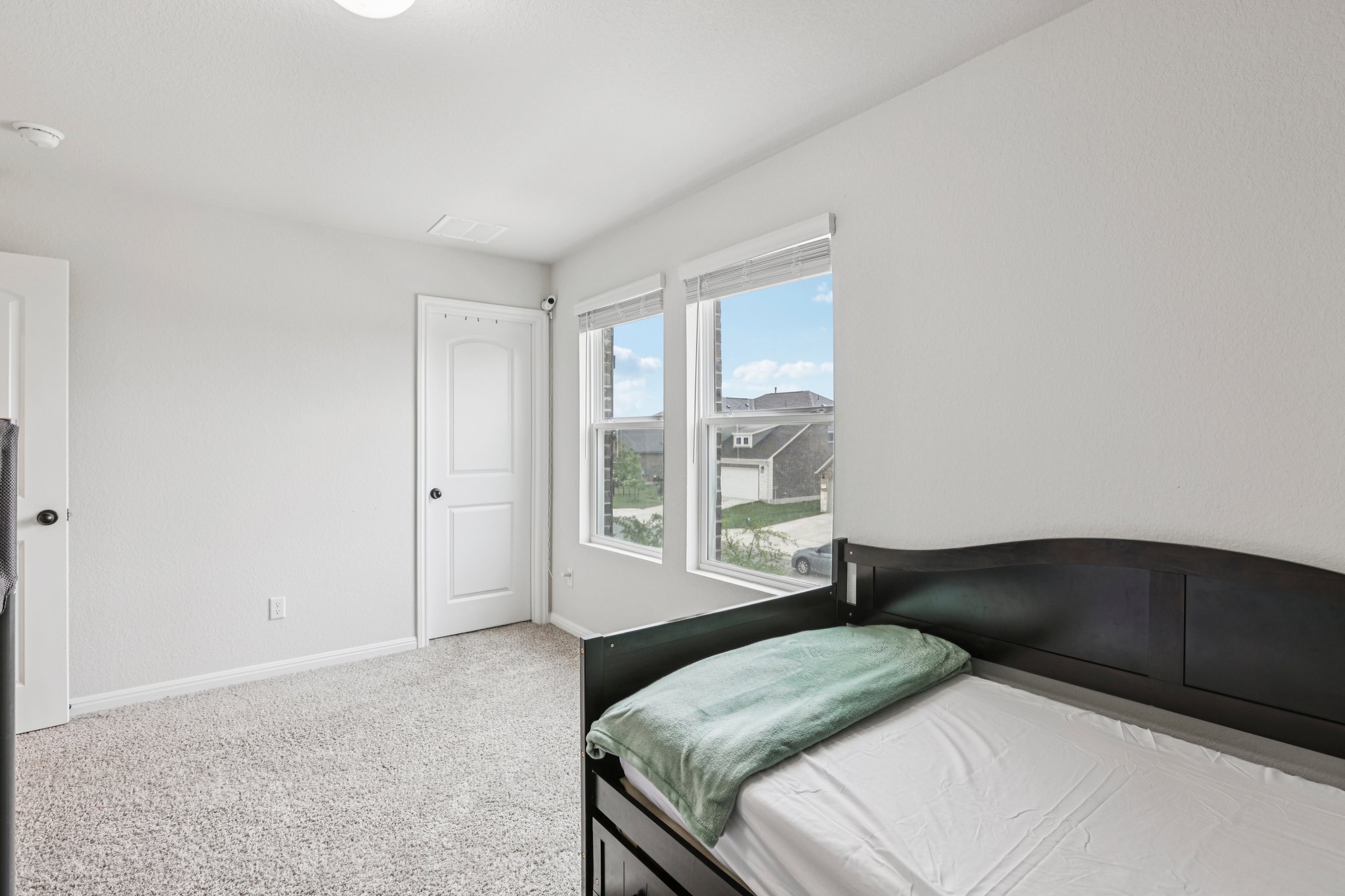 204 Swinging H Lane Georgetown, TX 78633 - Photo 30 of 39 Room featuring light gray walls, two white doors with black hardware, and carpeted flooring