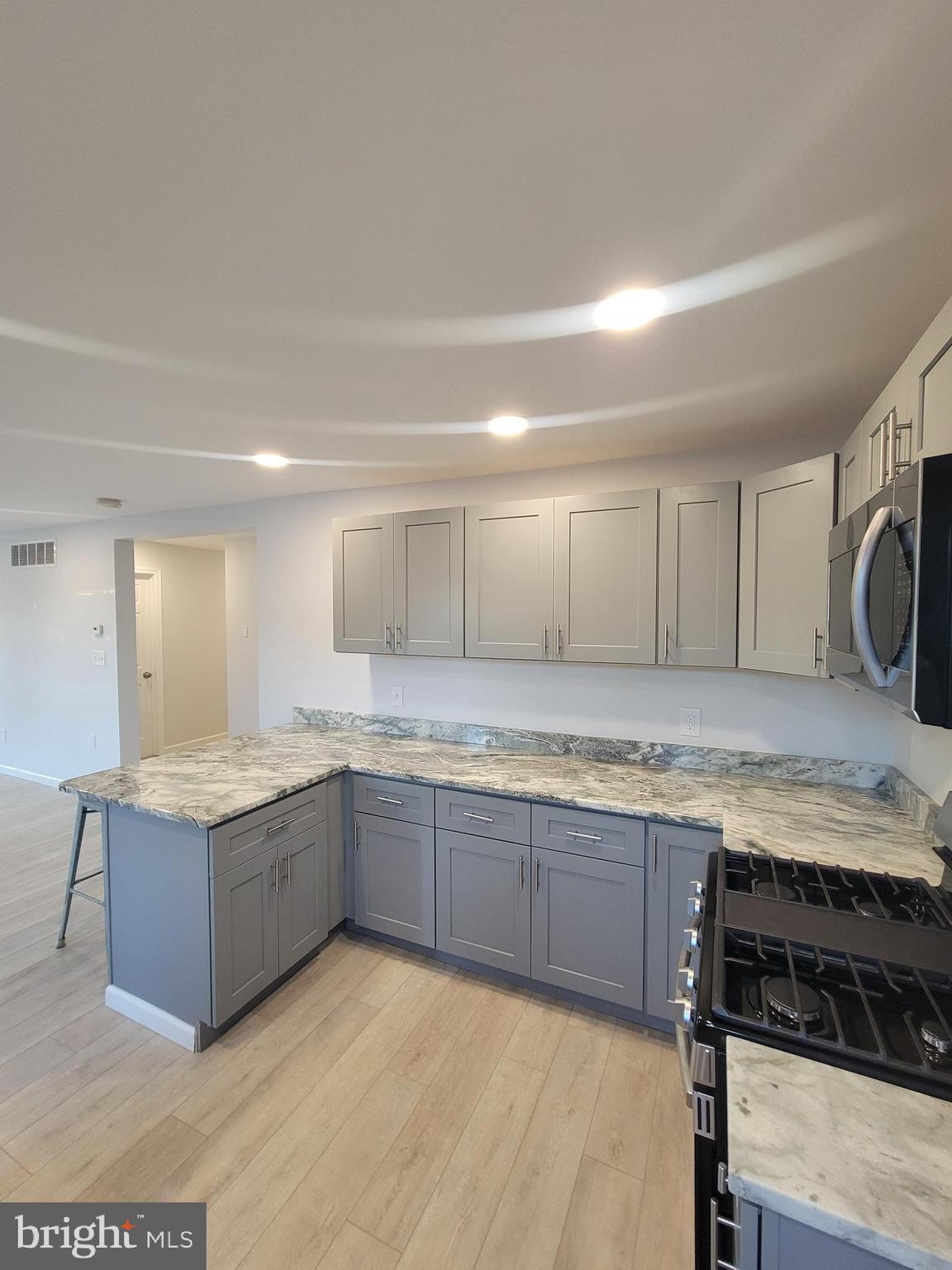 2621 North Snyder Avenue Sparrows Point, MD 21219 - Photo 11 of 65 a kitchen with granite countertop a sink and white cabinets