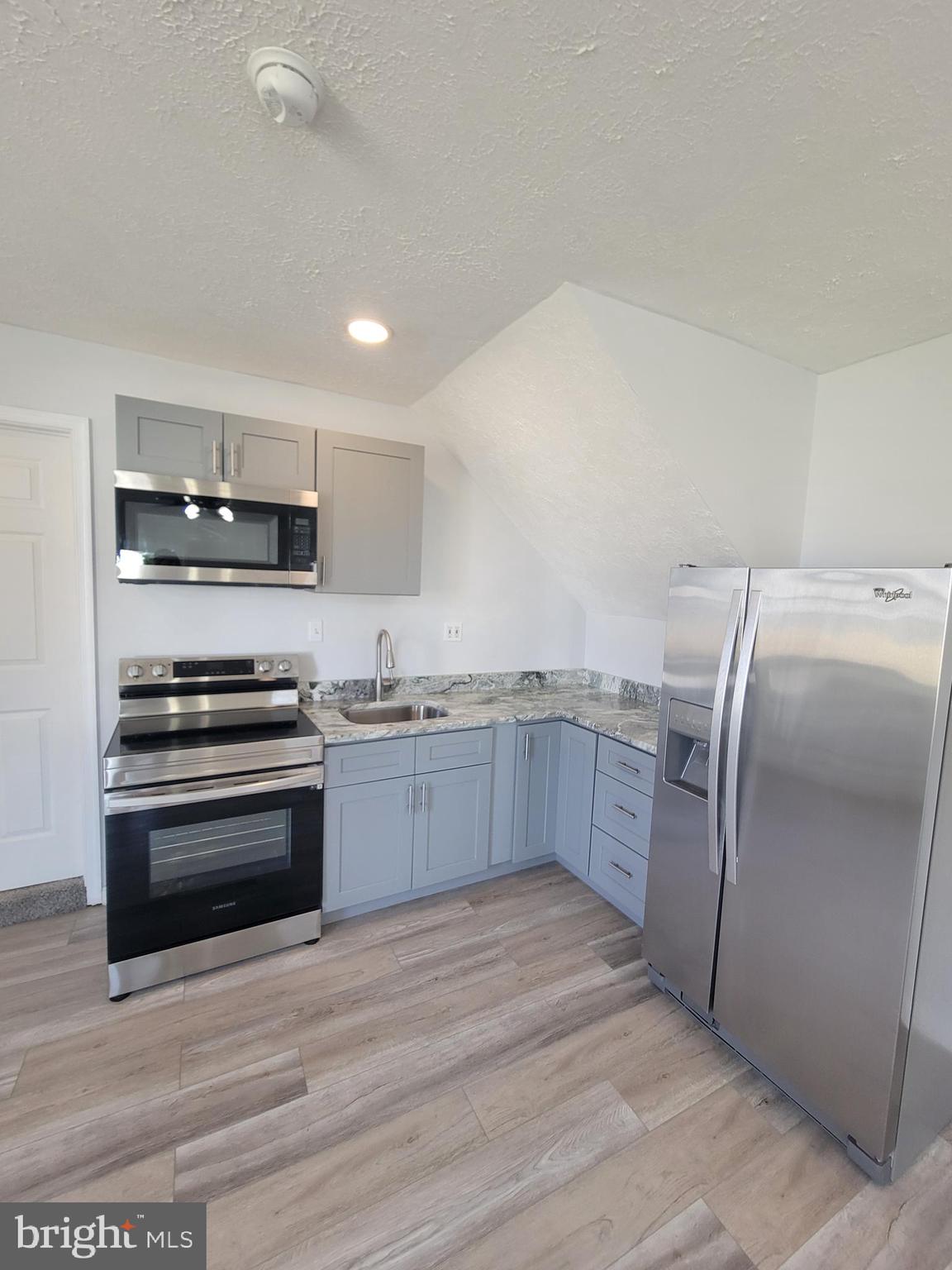 2621 North Snyder Avenue Sparrows Point, MD 21219 - Photo 44 of 65 a kitchen with stainless steel appliances granite countertop a refrigerator and a stove