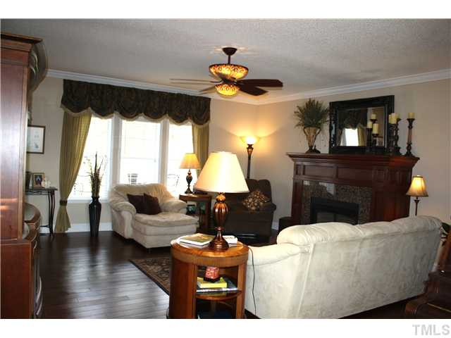 925 Quarterhorse Road Princeton, NC 27569 - Photo 8 of 21 FAMILY ROOM WITH CROWN MOLDING AND LAMINATED HARDWOOD FLOORS*GRAND MANTEL FIREPLACE