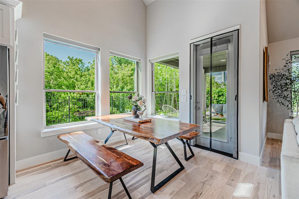 1070 Adair Road Prosper, TX 75078 - Photo 8 of 40 Light wood-finish flooring enhances this dining area, featuring a full-light glass door providing exterior access