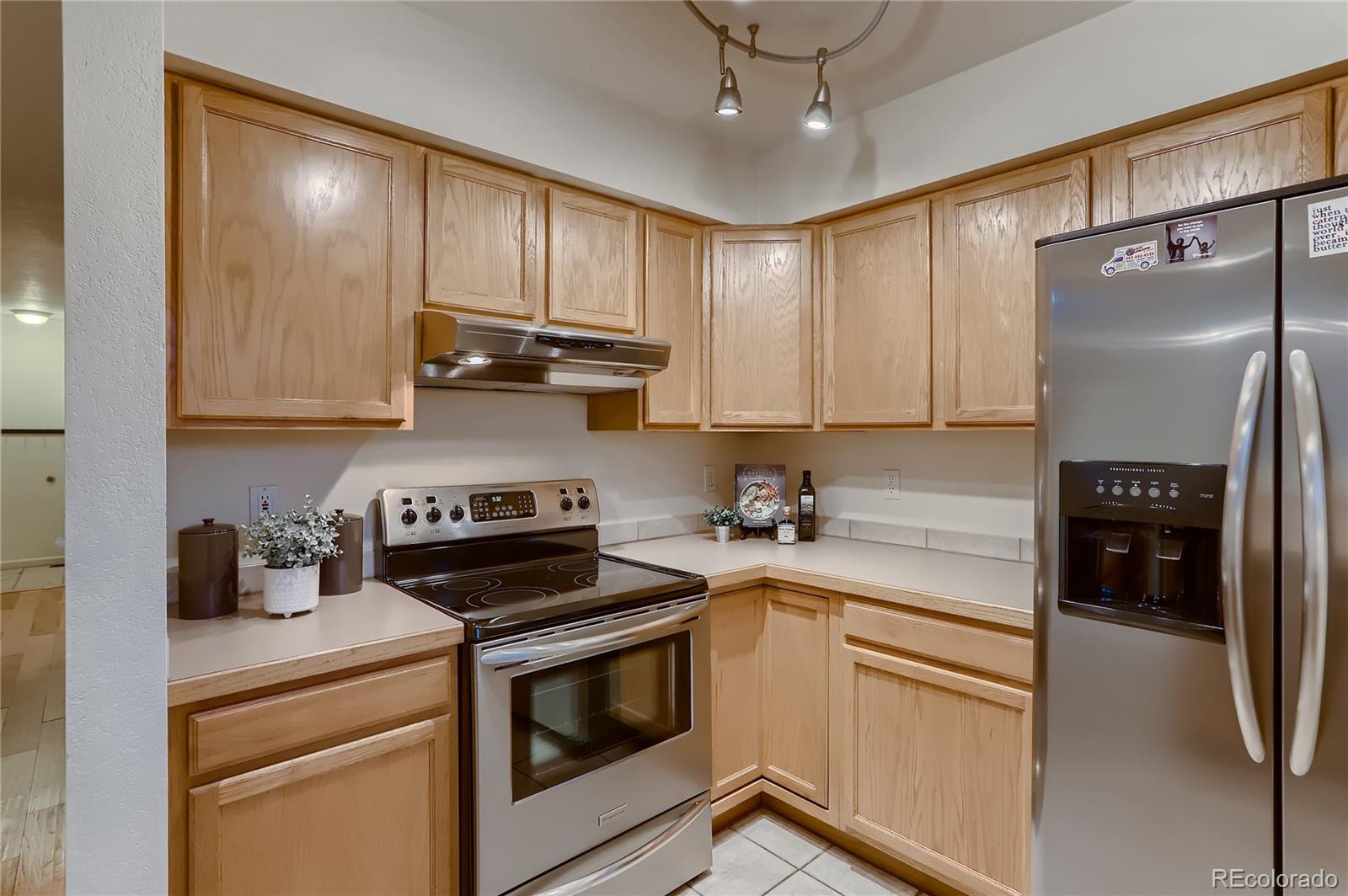 4640 15th Street, Unit D Boulder, CO 80304 - Photo 12 of 28 a kitchen with stainless steel appliances granite countertop a refrigerator sink and stove