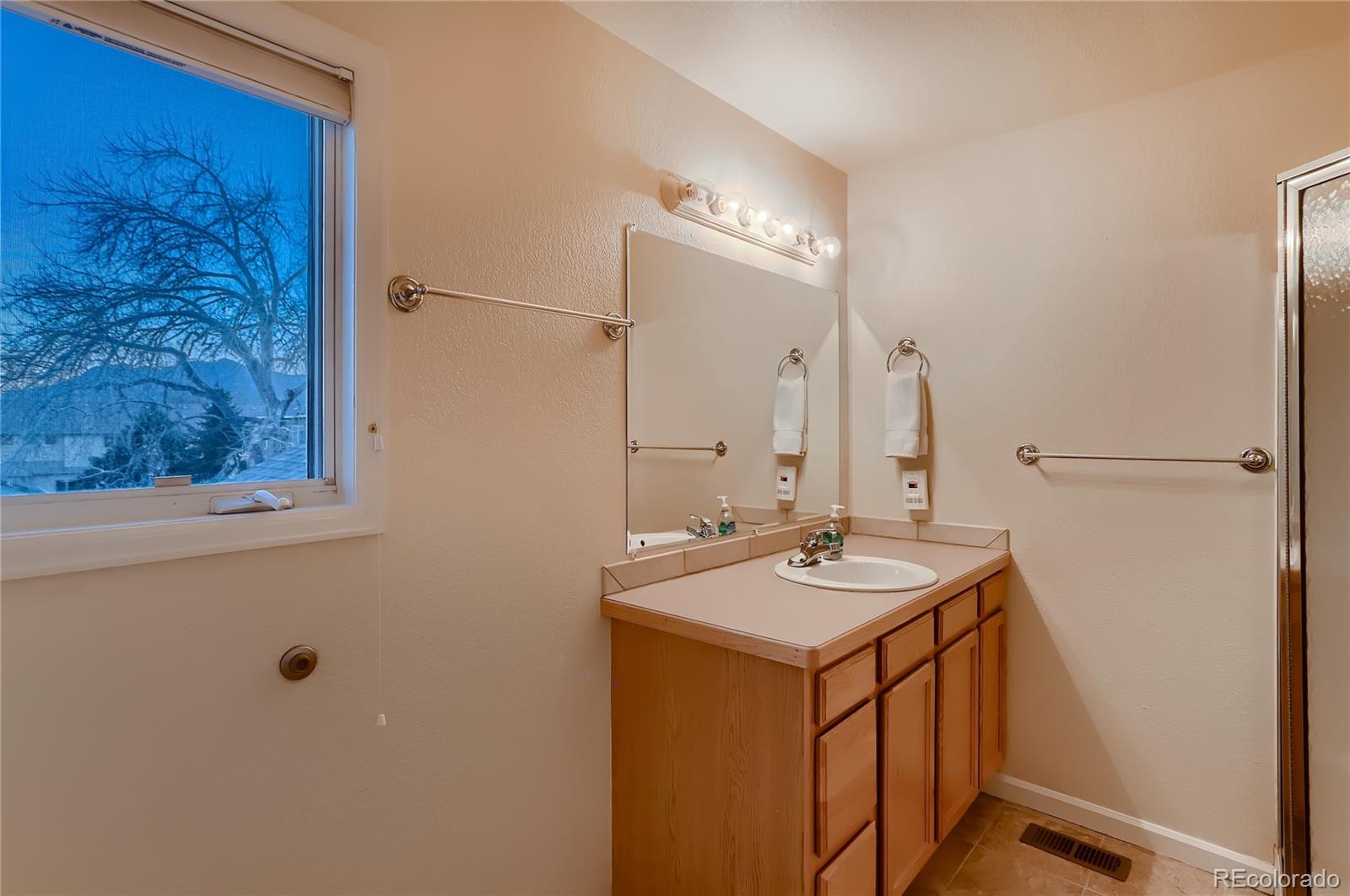 4640 15th Street, Unit D Boulder, CO 80304 - Photo 18 of 28 a bathroom with a sink and a mirror