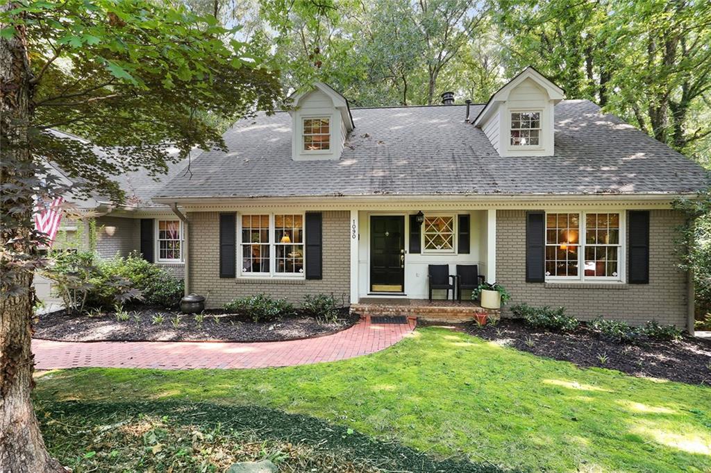 1090 Martin Ridge Road Roswell, GA 30076 - Photo 1 of 1 a front view of a house with a yard and outdoor seating