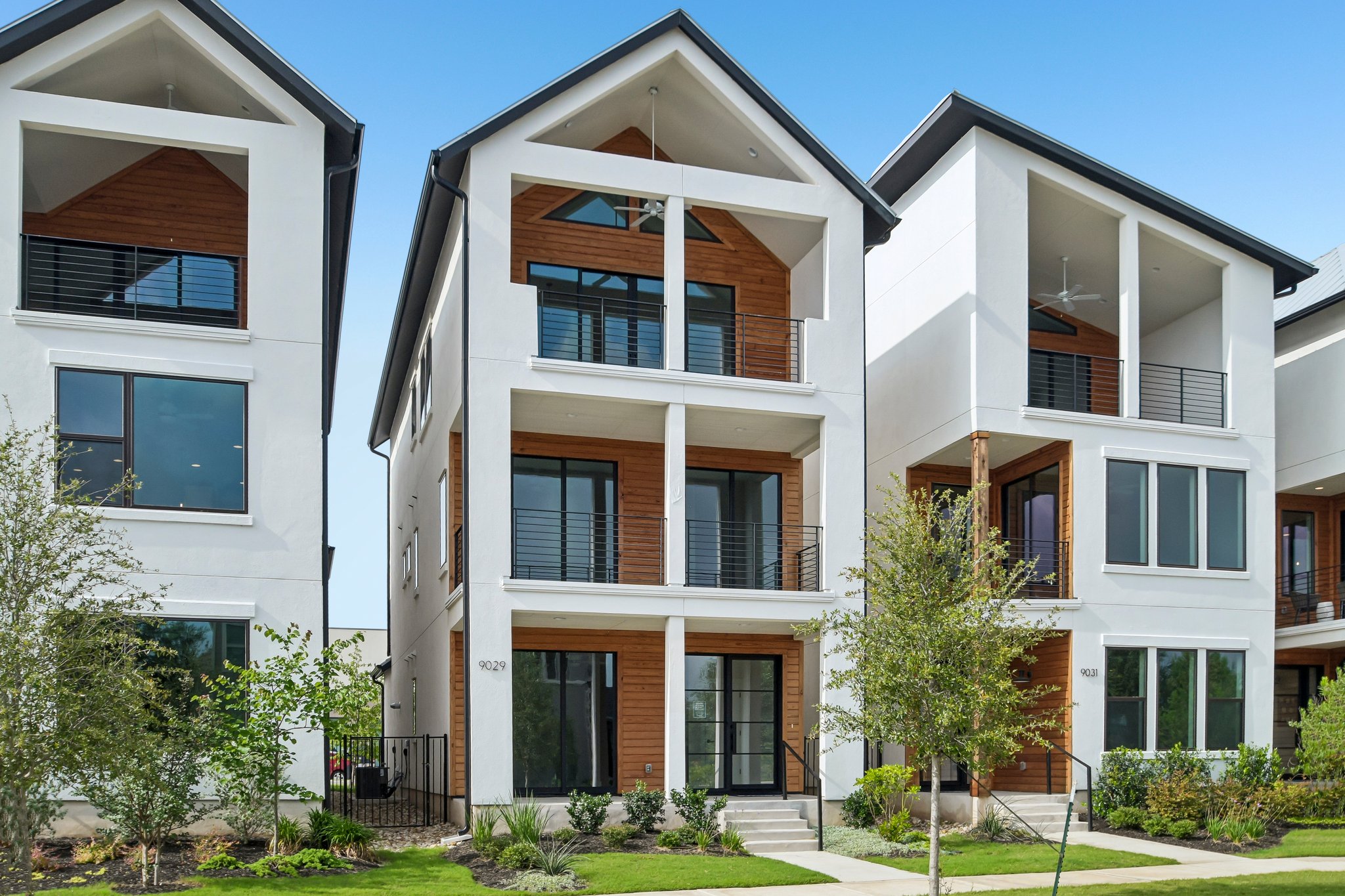 9029 Cattle Baron Path Austin, TX 78747 - Photo 2 of 37 Bold modern architecture defines this residence, featuring prominent balconies and rich wood accents for striking curb appeal.