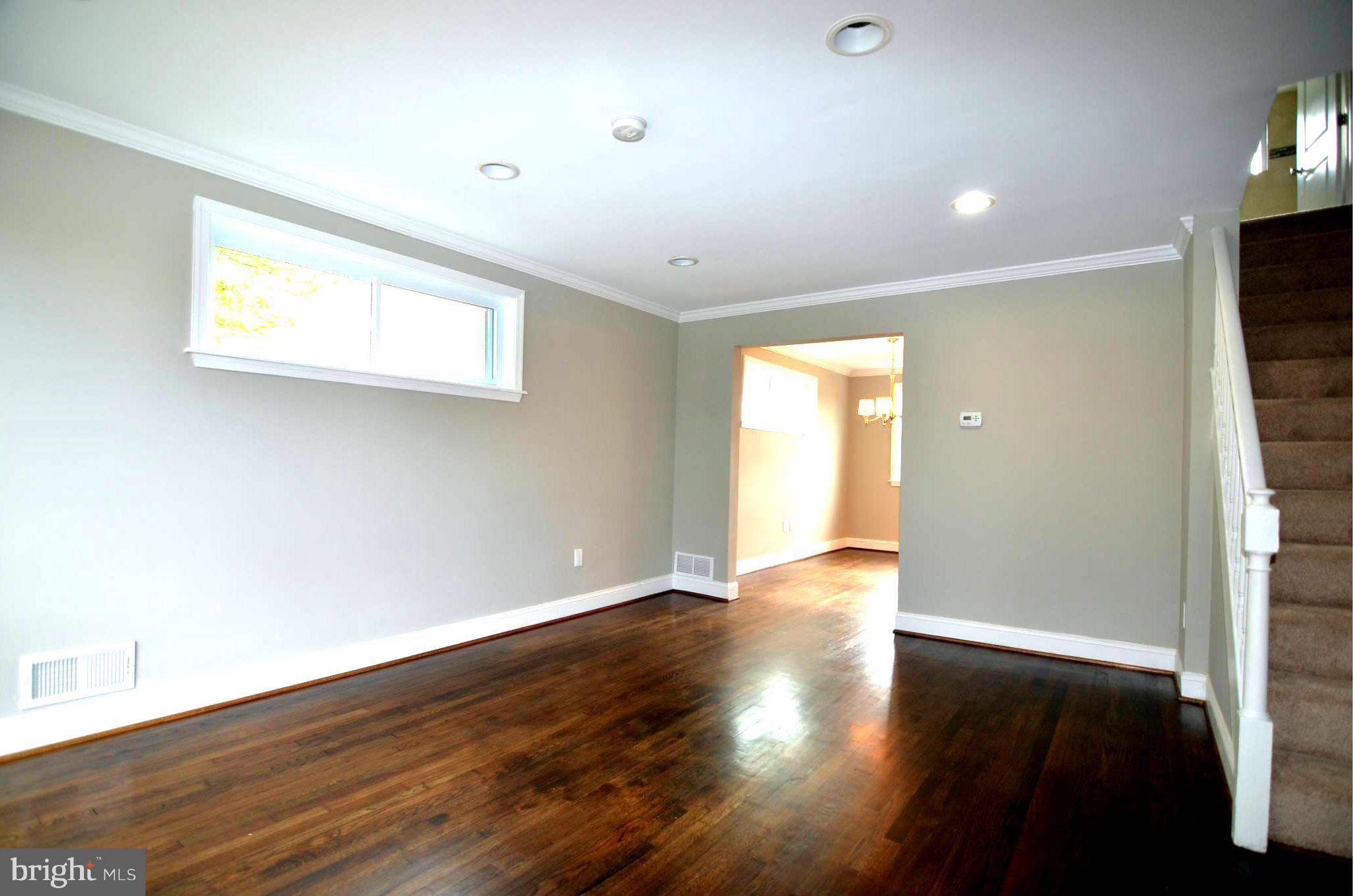 8254 Kavanagh Road Baltimore, MD 21222 - Photo 2 of 20 an empty room with wooden floor and windows