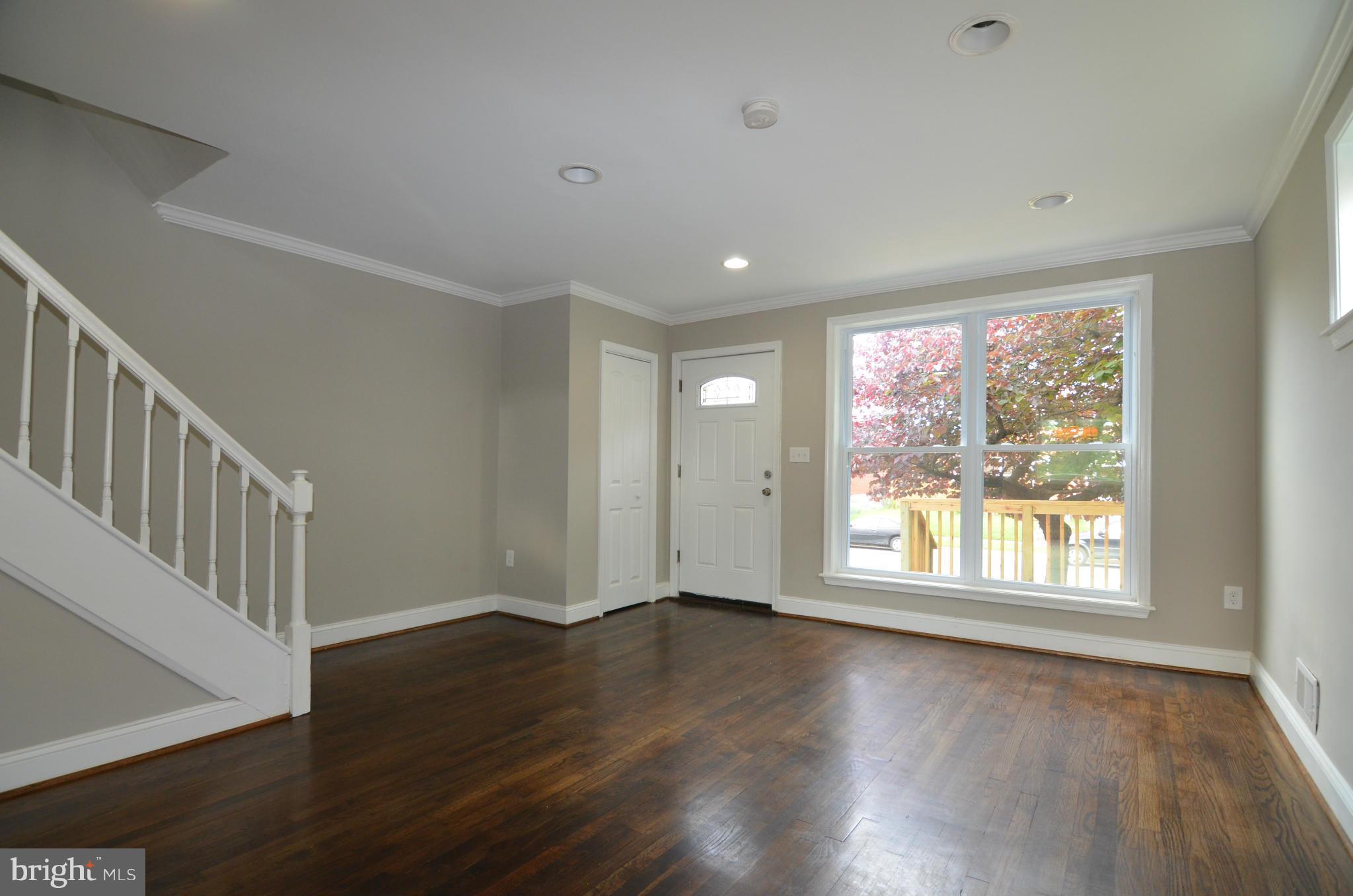 8254 Kavanagh Road Baltimore, MD 21222 - Photo 4 of 20 a view of an empty room with wooden floor and a window