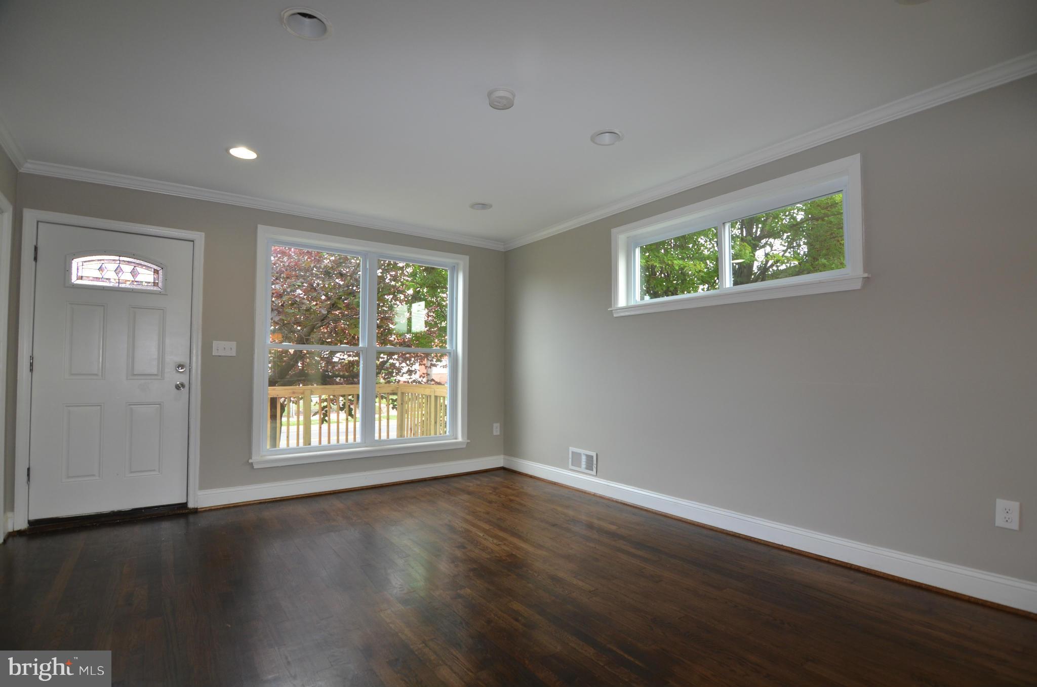 8254 Kavanagh Road Baltimore, MD 21222 - Photo 5 of 20 a view of an empty room with wooden floor and a window