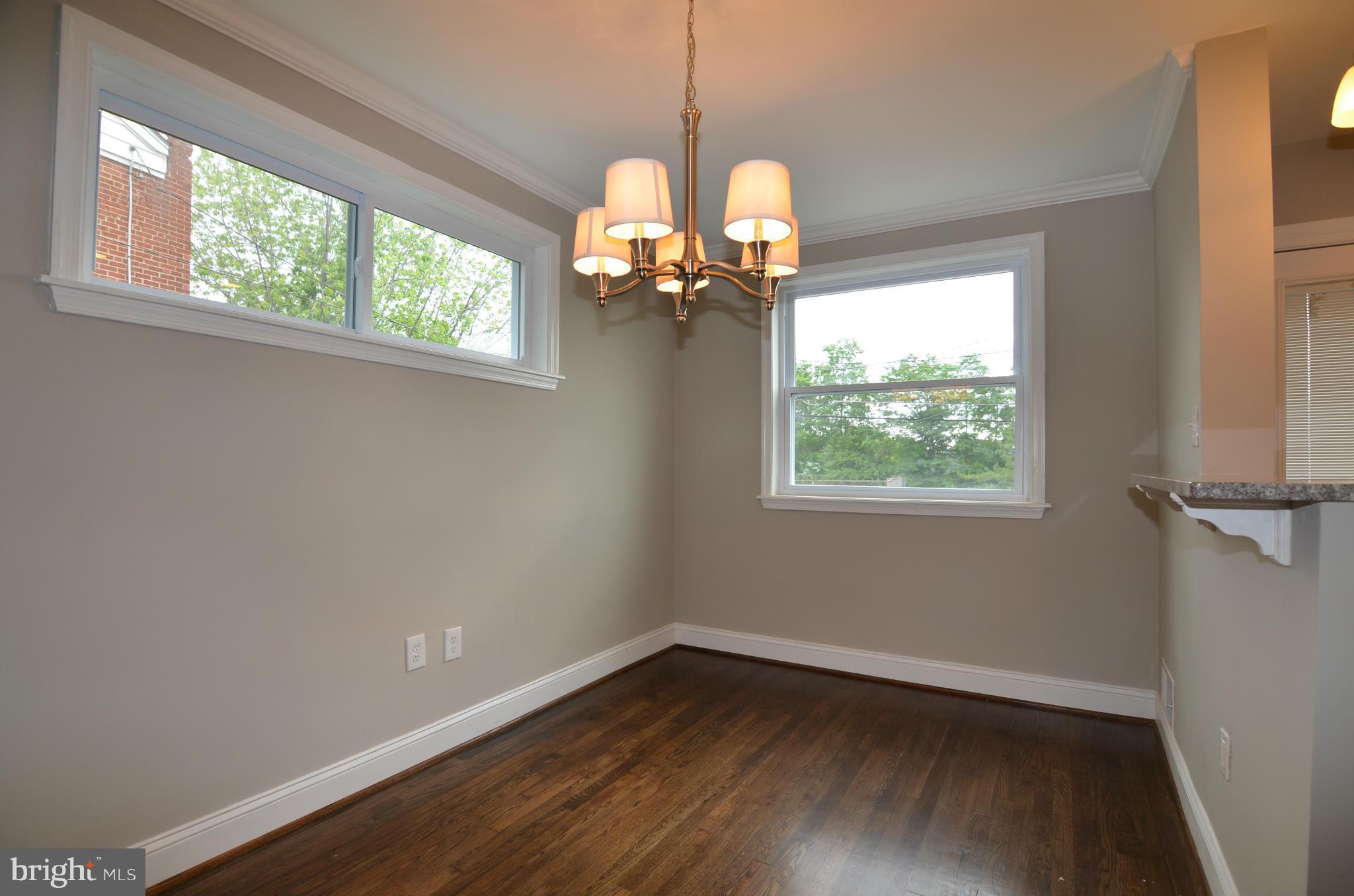 8254 Kavanagh Road Baltimore, MD 21222 - Photo 8 of 20 a view of a room with wooden floor fan and windows