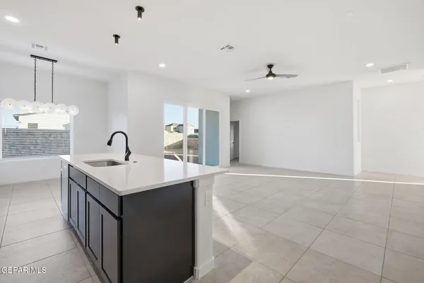 a kitchen with a sink a counter space appliances and cabinets