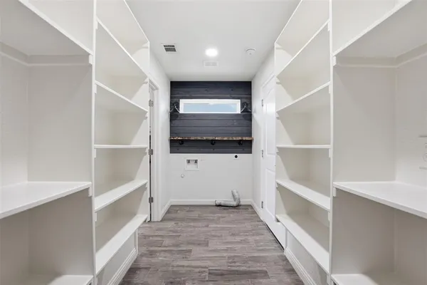 a view of hallway with stairs and wooden floor