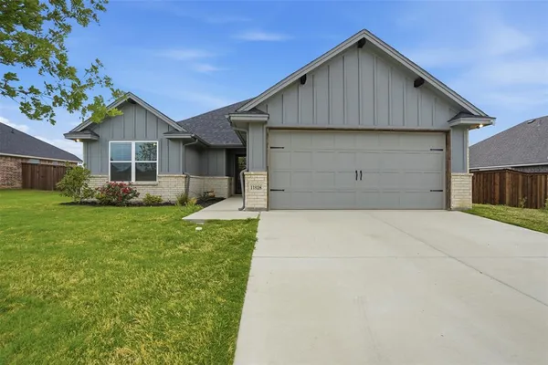 a front view of house with a yard and garage