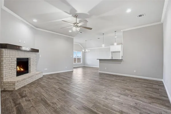 a view of an empty room with a fireplace and a window