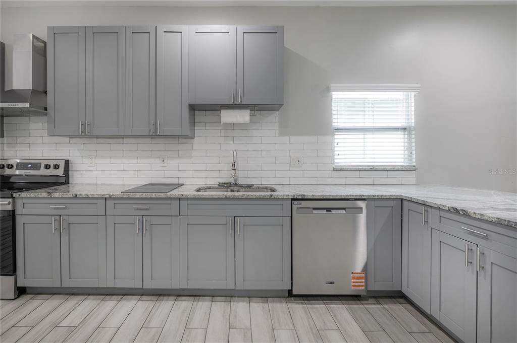 2341 West Chestnut Street Tampa, FL 33607 - Photo 11 of 42 a kitchen with stainless steel appliances granite countertop a sink and cabinets