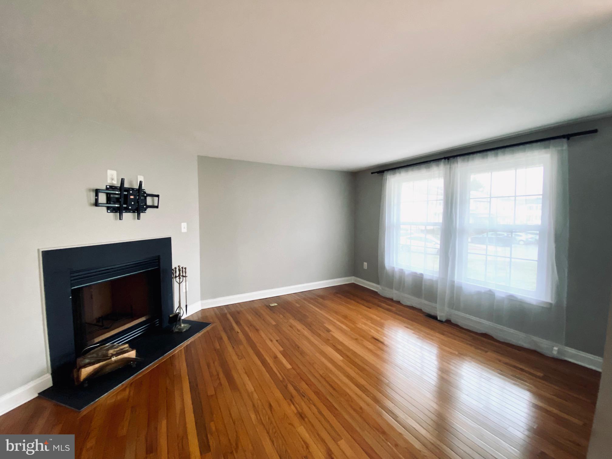 7266 Procopio Circle Columbia, MD 21046 - Photo 2 of 18 a view of empty room with wooden floor and fireplace