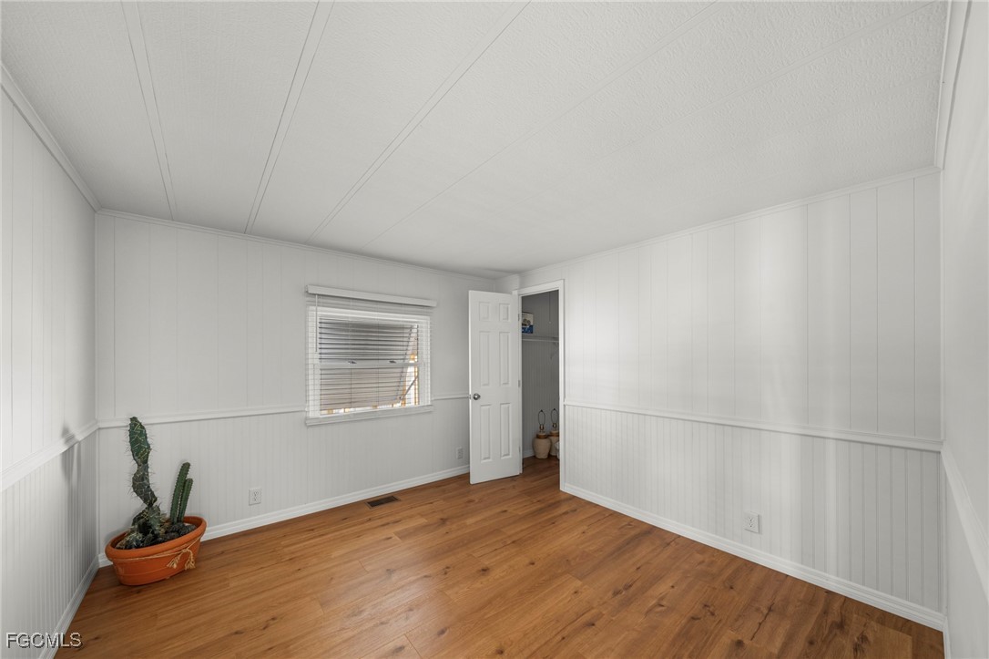 2971 York Road St. James City, FL 33956 - Photo 13 of 23 a view of an empty room with wooden floor and a window