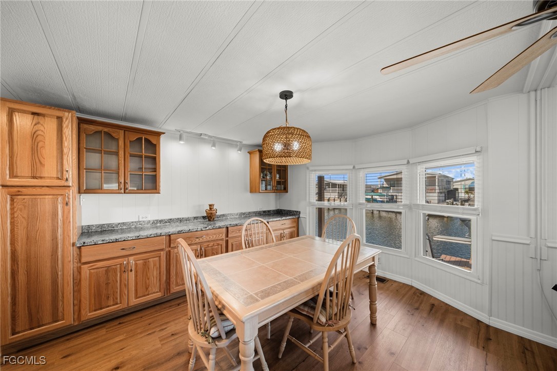 2971 York Road St. James City, FL 33956 - Photo 4 of 23 a view of a dining room with furniture and wooden floor