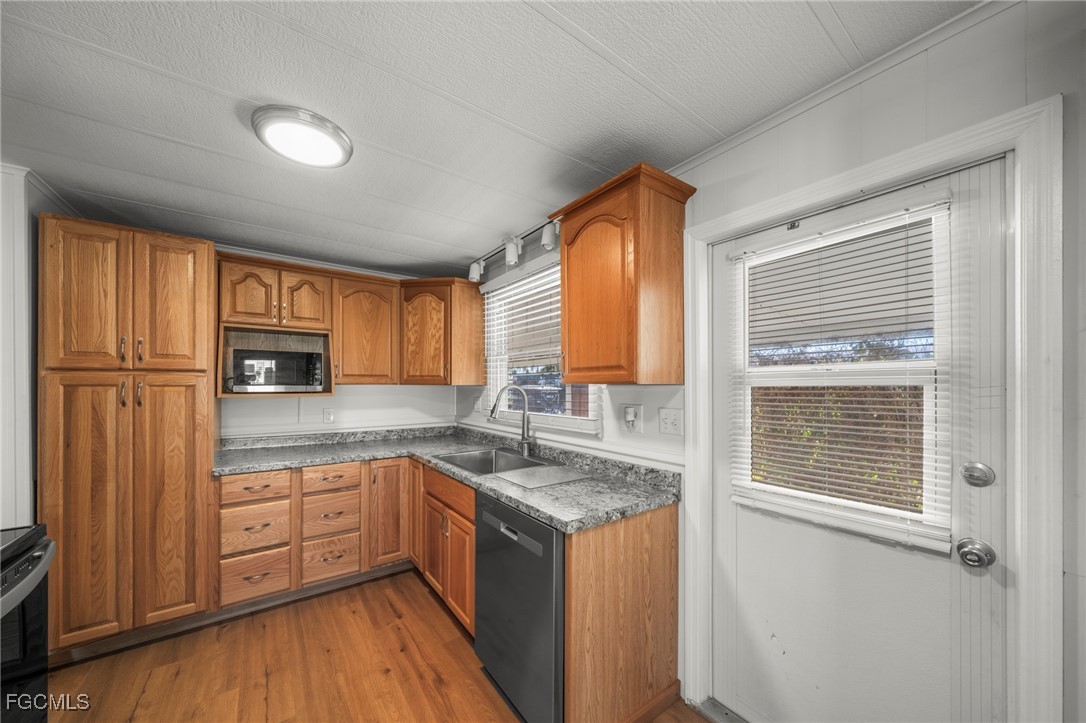 2971 York Road St. James City, FL 33956 - Photo 9 of 23 a kitchen with granite countertop stainless steel appliances sink and cabinets