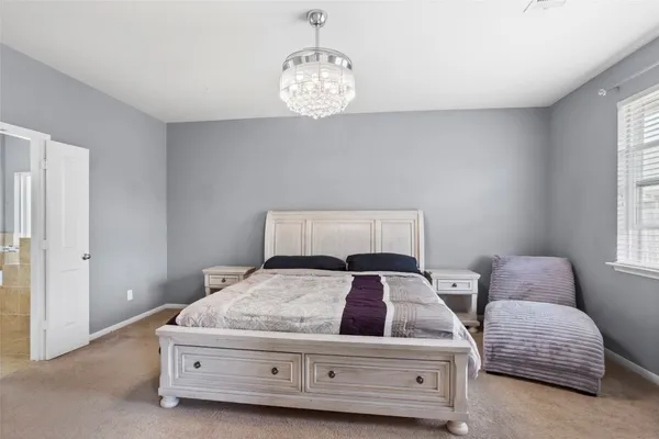 a bedroom with bed and a window