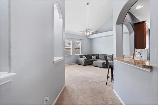 a living room with furniture and a chandelier