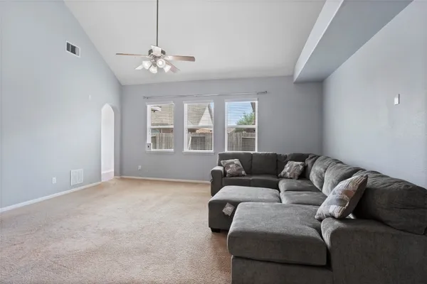 a living room with furniture and a chandelier