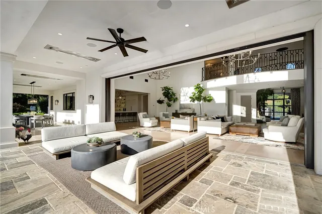 a kitchen with stainless steel appliances kitchen island a table chairs sink and cabinets