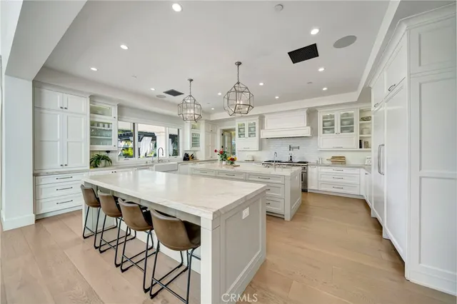 a living room with furniture a fireplace and a chandelier