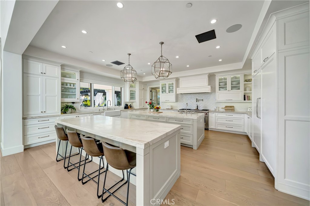 2037 Delphine Lane Calabasas, CA 91302 - Photo 16 of 75 a kitchen with stainless steel appliances kitchen island a table chairs sink and cabinets