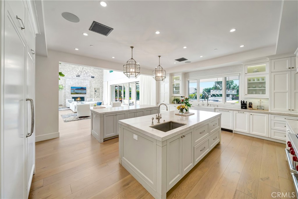 2037 Delphine Lane Calabasas, CA 91302 - Photo 18 of 75 a large white kitchen with a large counter top space a sink stainless steel appliances and cabinets