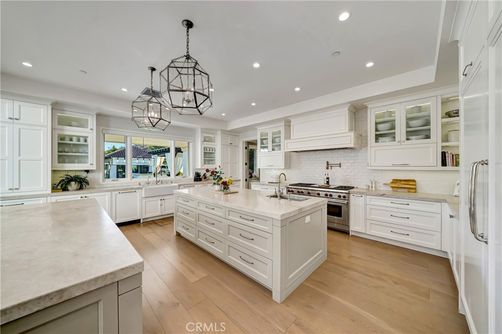 2037 Delphine Lane Calabasas, CA 91302 - Photo 19 of 75 a large kitchen with stainless steel appliances granite countertop a stove oven and a white cabinets