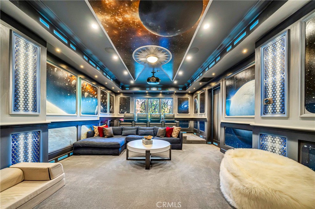 2037 Delphine Lane Calabasas, CA 91302 - Photo 21 of 75 a living room with furniture a fireplace and a chandelier