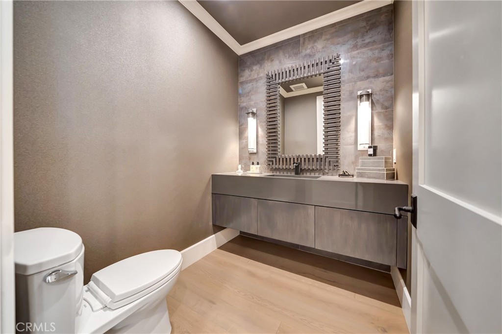 2037 Delphine Lane Calabasas, CA 91302 - Photo 24 of 75 a bathroom with a sink a toilet a mirror and vanity