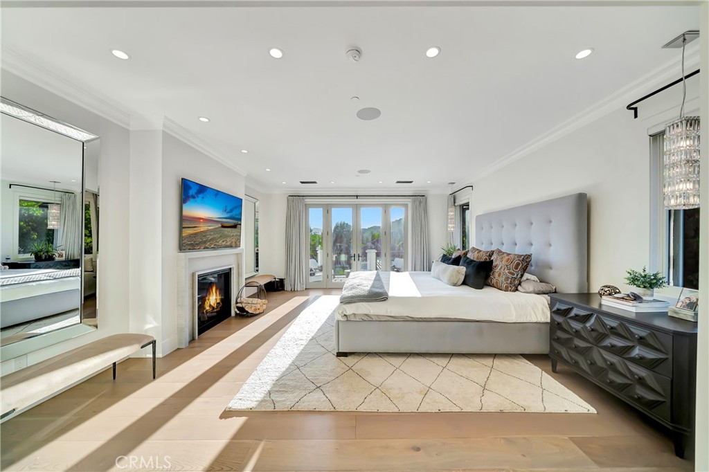 2037 Delphine Lane Calabasas, CA 91302 - Photo 27 of 75 a spacious bedroom with a large bed and a fireplace