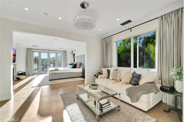 a bedroom with a large bed and a large mirror