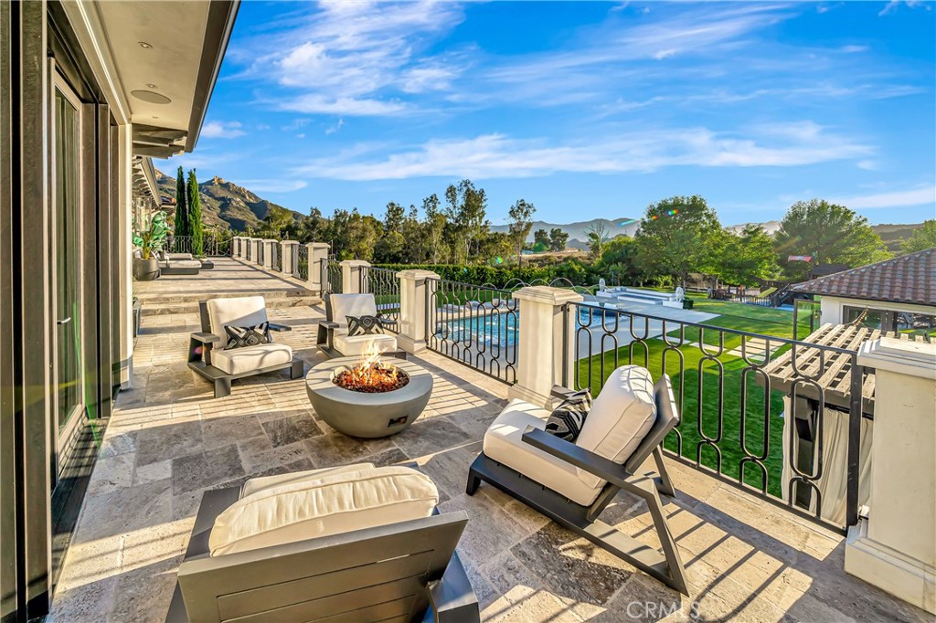 2037 Delphine Lane Calabasas, CA 91302 - Photo 29 of 75 a view of a chair and tables back yard of the house
