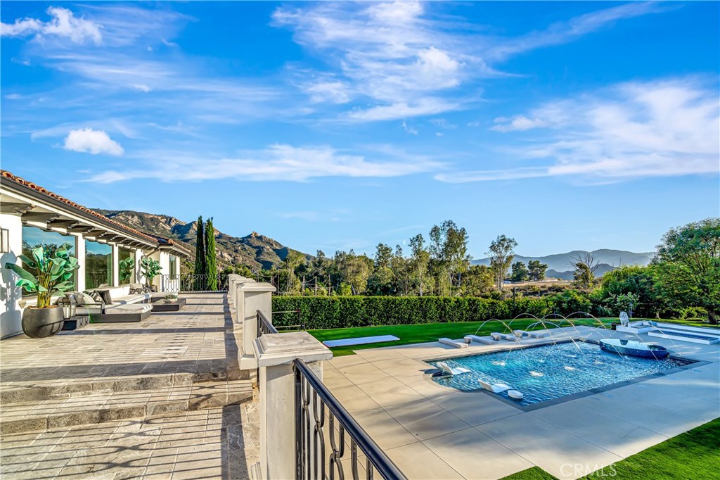 2037 Delphine Lane Calabasas, CA 91302 - Photo 30 of 75 a view of a patio with a table and chairs