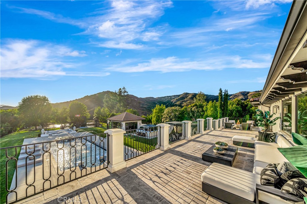 2037 Delphine Lane Calabasas, CA 91302 - Photo 31 of 75 a view of a balcony with two chairs and a table