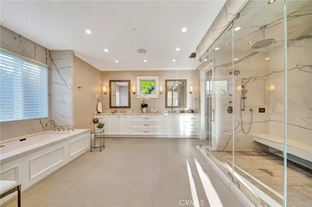 a bedroom with furniture and a chandelier