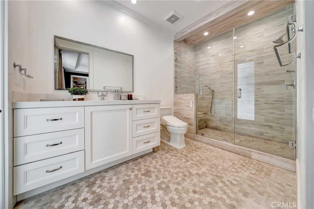 2037 Delphine Lane Calabasas, CA 91302 - Photo 35 of 75 a bathroom with a toilet a sink a mirror a bathtub and vanity